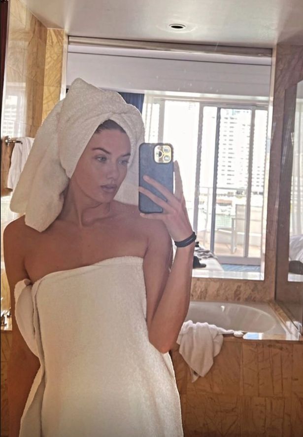 Alicia Schmidt, who has been called "the world's sexiest athlete," poses for a selfie while just wearing a towel