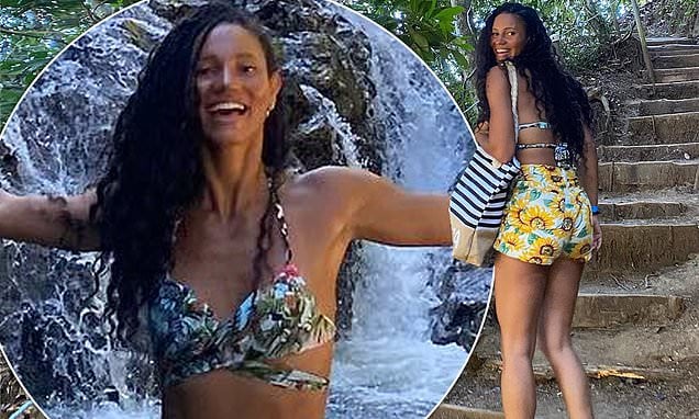 Vick Hope flaunts her toned abs in a bikini and a pair of shorts with a sunflower motif while on vacation - "DO ACTUALLY RECOMMEND GOING CHASING WATERFALL"