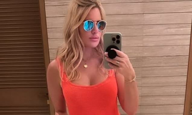 Pregnant Danielle Armstrong shows off her developing baby bulge in an orange bikini and £380 Gucci sandals during a luxury family vacation to Dubai