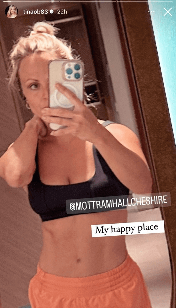 A teeny black sports bra gives Tina O'Brien the appearance of washboard abs