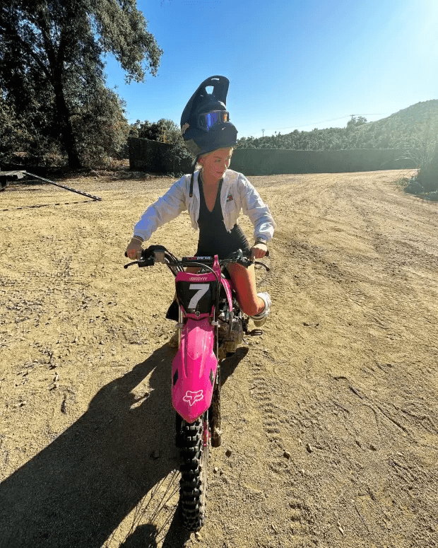 In a daring outfit, golf influencer Katie Sigmond rides a dirtbike to tease fans to jump on