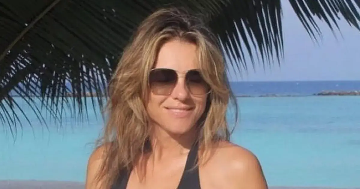 Fans swoon as Elizabeth Hurley strips to a plunging wide-open swimsuit for a racy beach photo