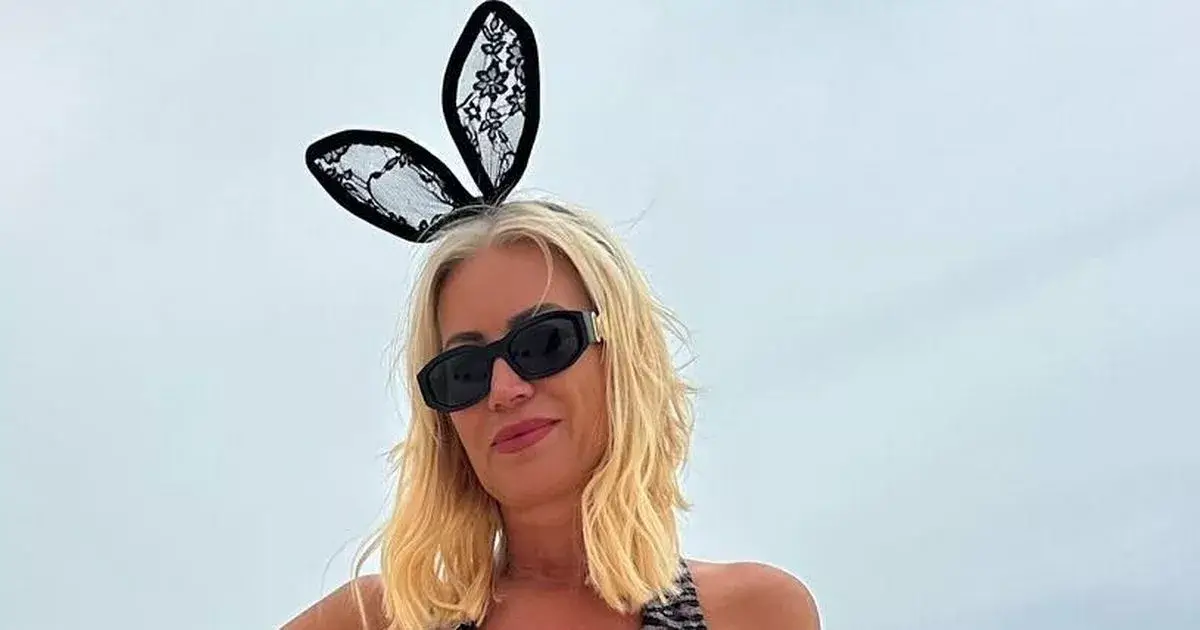 Denise Van Outen posed in a plunging swimsuit and bunny ears to be a racy bunny on the golden sand