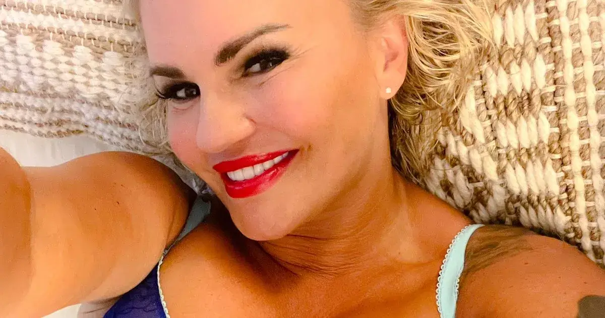 In a racy snap, Kerry Katona exposes her killer curves in a see-through blue bra and matching knickers