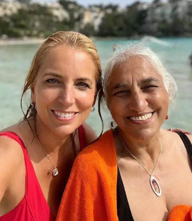 Her beachy outfit consisted of a bright red swimsuit and silver earrings with a stunning pendant necklace adding to her gorgeous beachy look.