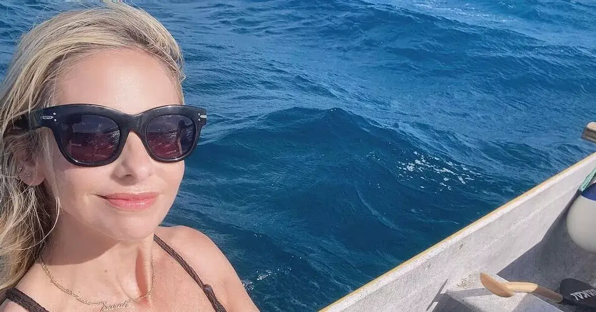 A tiny black swimsuit showed off Sarah Michelle Gellar’s killer figure as she slips into it for ocean snaps