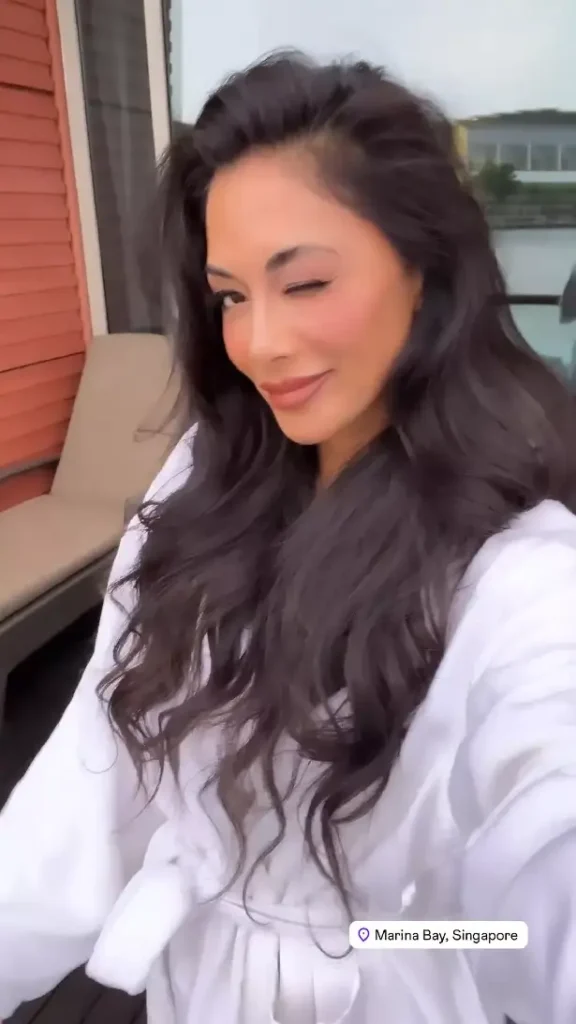 In a behind-the-scenes video late last month, Nicole Scherzinger can be seen keeping warm in a soft white robe while filming a close-up of her face.
