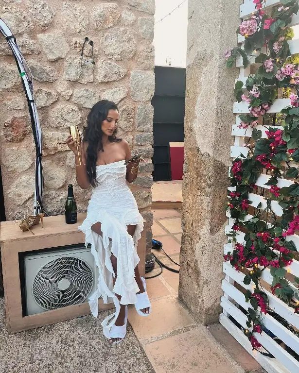 With a plunging white dress and a mesmerising beauty, Maya Jama showcases her jaw-dropping curves and branded 'perfection'