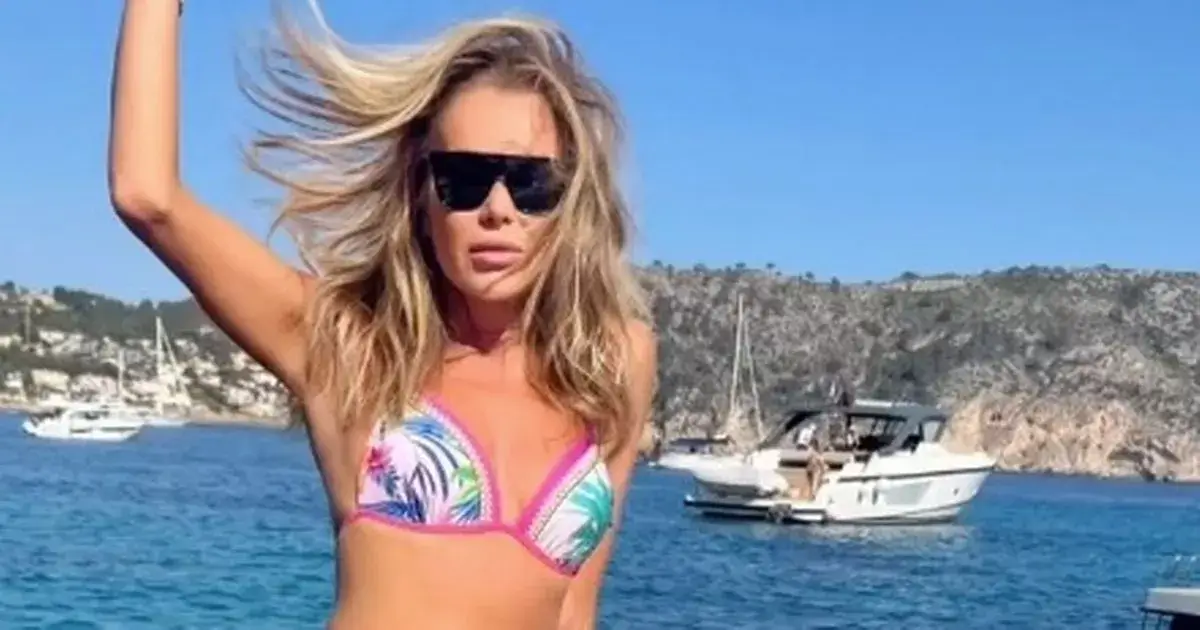 Amanda Holden, 53, flaunts her incredible physique in a tiny colourful bikini as she balances on the side of a boat