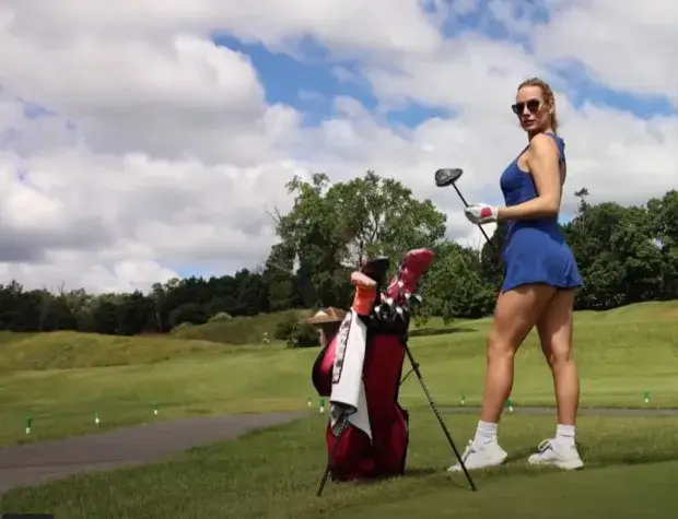 When Paige Spiranac wore a short blue dress, she faced a wardrobe malfunction as the skirt's hem threatened to ride up