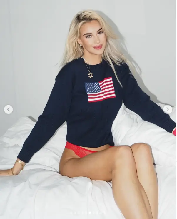 Veronika Rajek wore a cropped sweatshirt with a U.S. flag on the front, showing off a golden tan and her blonde locks down .