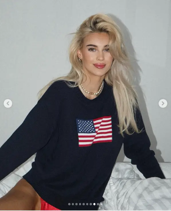 A cropped, navy blue sweatshirt with a U.S. flag on the front makes Veronika Rajek seem jaw-dropping while braless