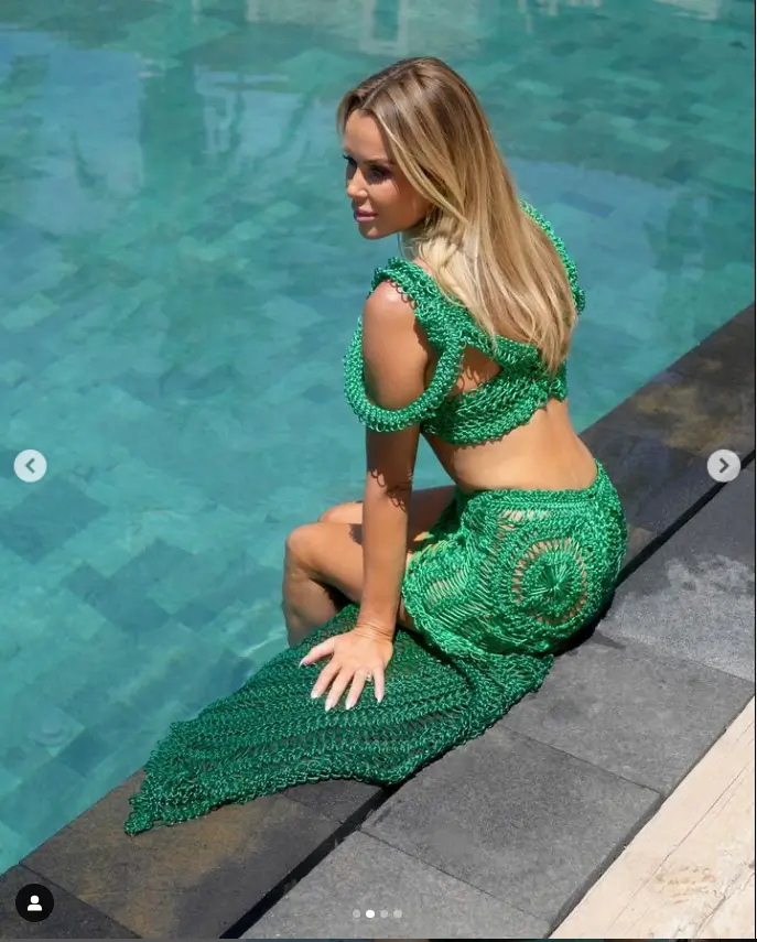 Amanda Holden looks absolutely stunning in a see-through green crocheted dress while taking a dip in Spain