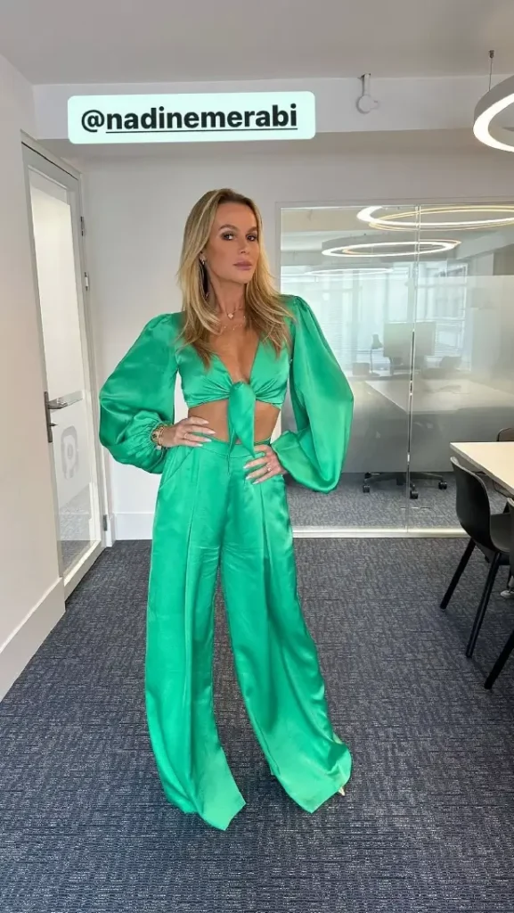 Amanda Holden flashed her toned tummy in a green plunging two-piece from Nadine Merabi that lit up the Heart FM studios once again.