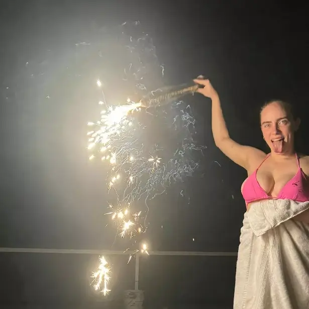 A series of selfies posted by Billie Eilish to Instagram this weekend included a picture of her in a tiny pink bikini while watching fireworks on the 4th of July.