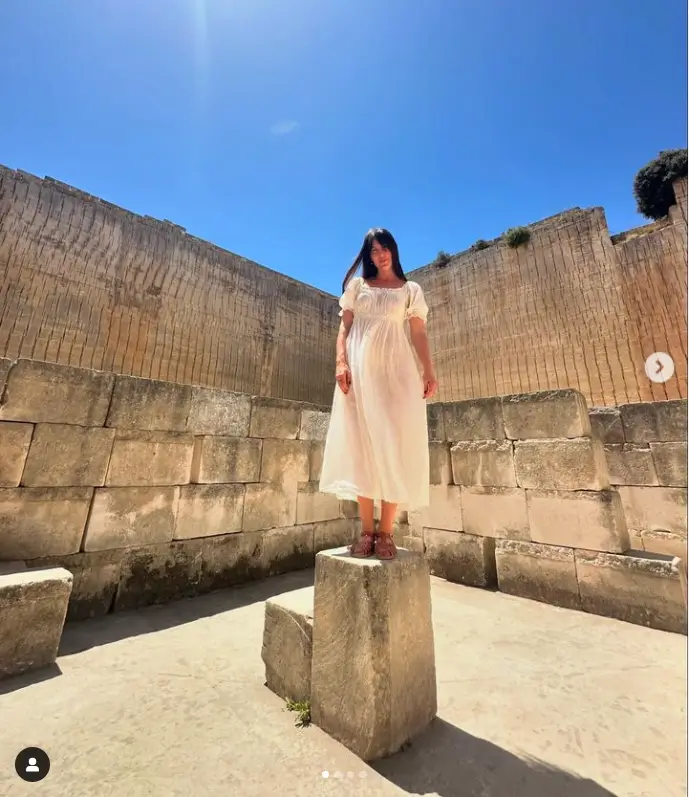 Among the images was Scout standing in a flowing white cotton dress amid stone ruins