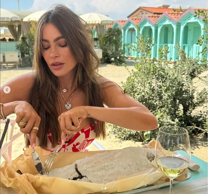 Sofia Vergara wears a braless sundress and digs into a giant plate of spaghetti as she enjoys her vacation with friends