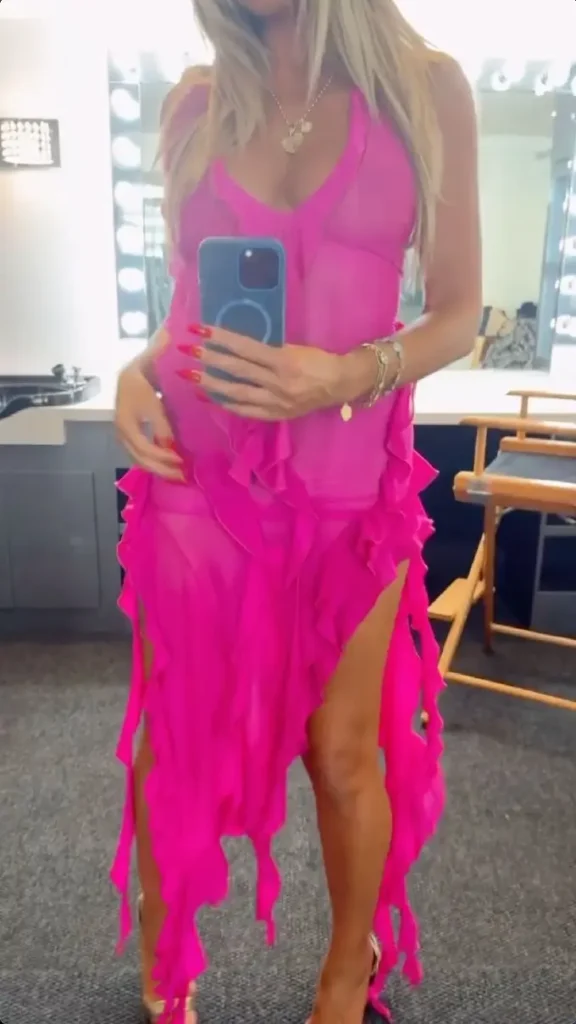 On Friday, Heidi Klum shared photos and clips from the filming of Paris Hilton's new music video on her Instagram Stories, showing off her plunging pink see-through dress.