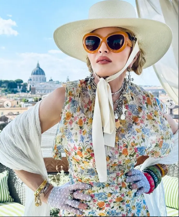 A new set of snaps showed Madonna dressed in a pretty, long floral dress and wearing a white scarf as she celebrated turning one year older in historic locations.