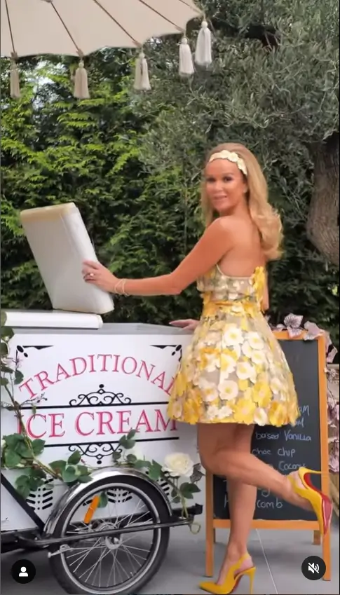 Amanda Holden looked sensational in a strapless yellow floral dress and revealed her svelte figure at an extravagant Palm Royale party at her mansion