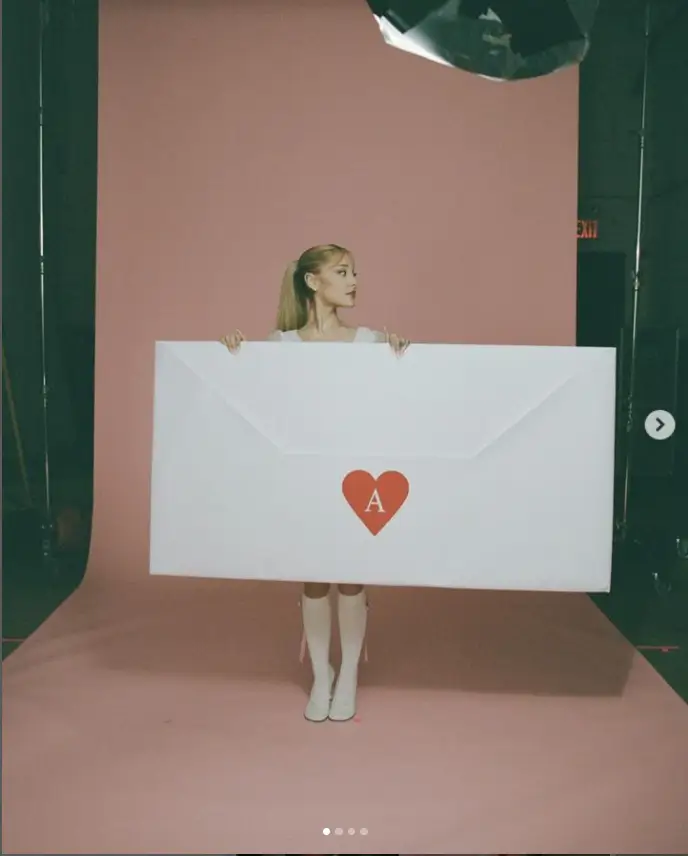 She also posed with a giant version of the letters, featuring a heart seal with an 'A'. The Wicked actress wore a white lace dress with matching knee-high stockings.