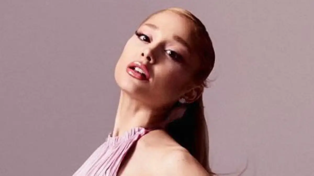 Ariana Grande struts her stuff in a billowing pink backless dress and sky-high heels as she debuts the campaign for her new fragrance