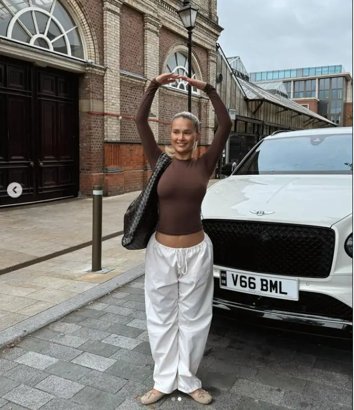 Taking a glimpse of herself with a white Bentley, Molly-Mae only underlined her affluence by also toting a handbag worth £2,500 from Bottega Vaneta.