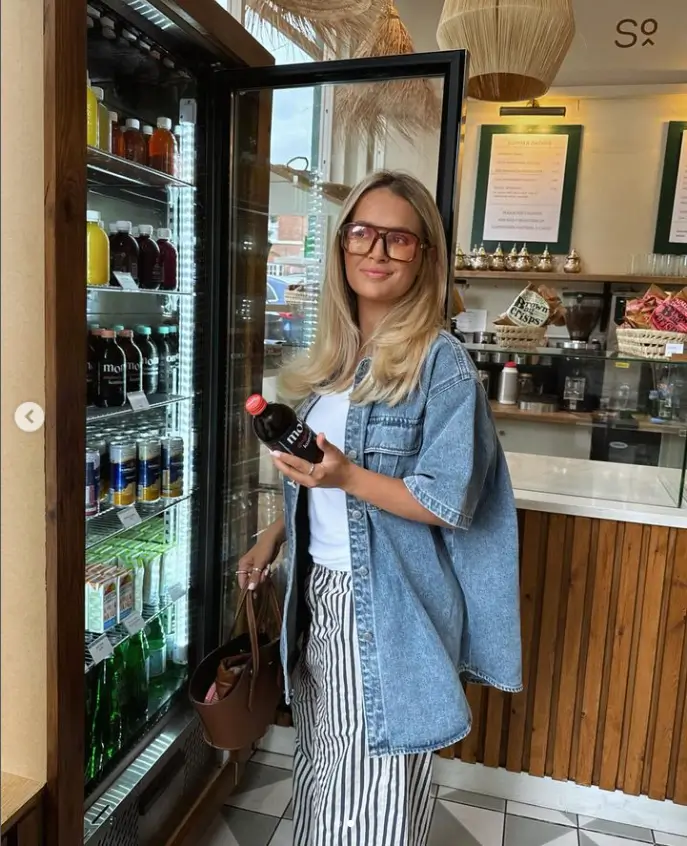 Molly-Mae Hague looks sensational in an oversized blue denim shirt and a pair of orange-tinted shades as she cut a stylish figure