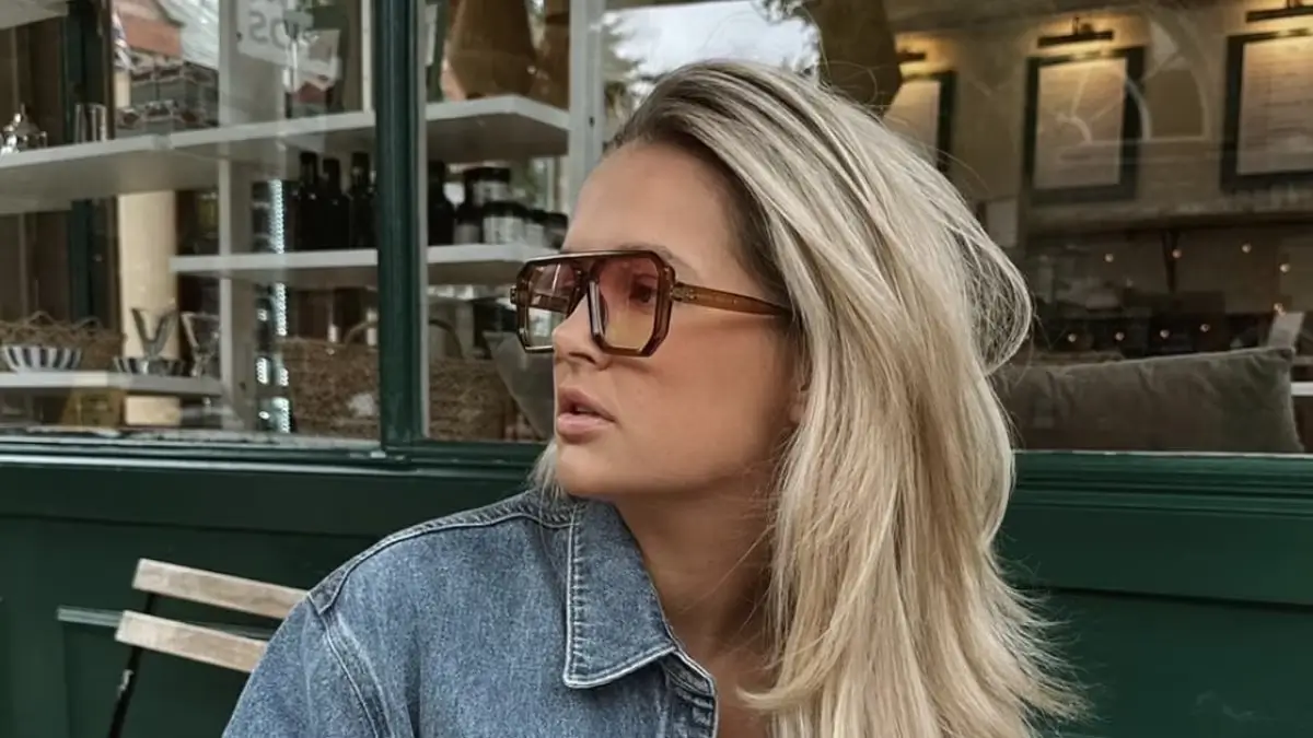 Molly-Mae Hague appeared sensational in an oversized blue denim shirt and orange-tinted shades while grabbing a drink in a cafe