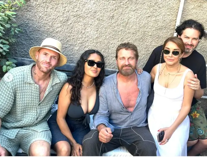 Salma looked amazing in her low-cut black dress while sitting on a bench with Gerard and friends for the group photo. Oliver Trevena, co-founder of Cali Water, and Michael Braun, a real estate executive who is close to Leonardo DiCaprio, also attended.