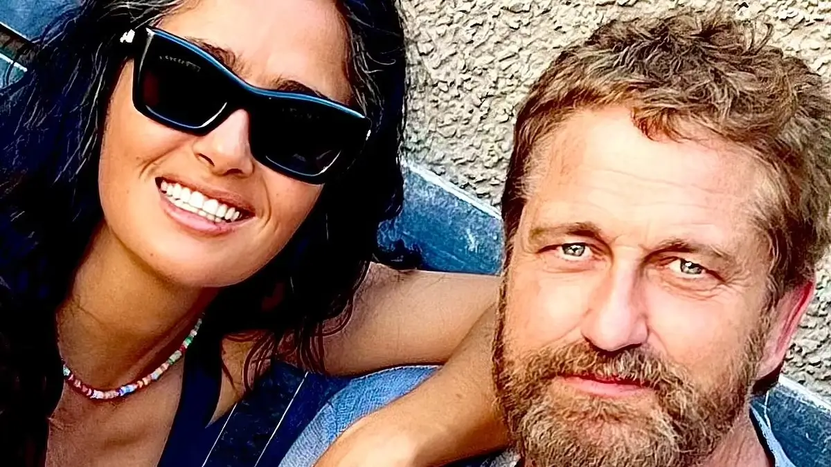 In a low-cut black dress, Salma Hayek enjoys an “unexpected run-in” with her friend Gerard Butler