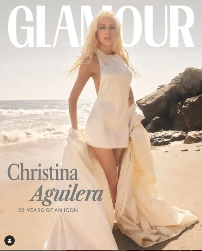 On the cover, she wore a small white dress with barely reach her thighs, and she was braless and holding a white sheet.