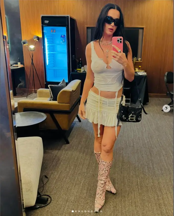 One of the singer's other photos showed her modeling a ripped white cami and low-waisted mini-skirt in grunge style, paired with knee-high boots covered in crocodile print.