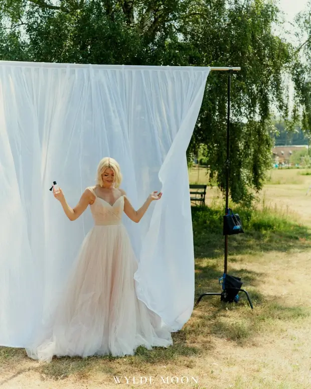 She looked incredible in a stunning white gown which featured a sweetheart neckline, off-the-shoulder straps, and tulle skirt.