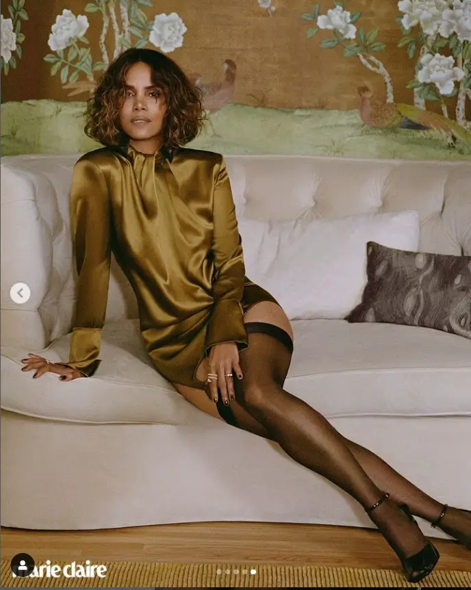 Her long legs are also visible in some photos, as she drapes over a sofa while wearing an olive green frock.