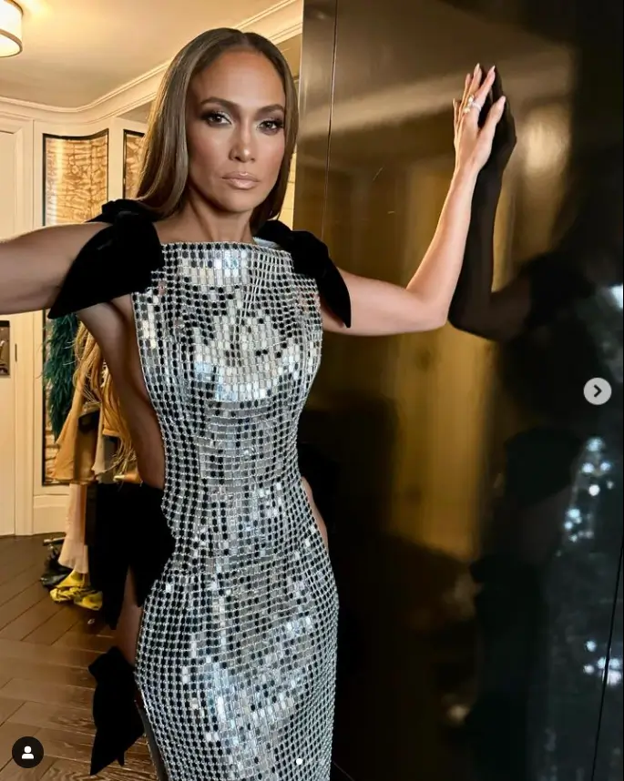 A silver dress, open at the sides, secured with just three black bows, made Jennifer Lopez the center of attention at Friday's premiere of Unstoppable at Roy Thomson Hall.