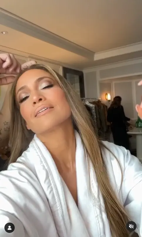 Jennifer Lopez flashed her toned abs and cleavage in a low-cut bathrobe, telling fans that this was "the cherry on top"