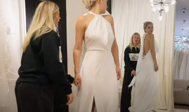 A white backless halter neck gown with a thigh-split and tie-up detail was Molly's outfit in the shop.