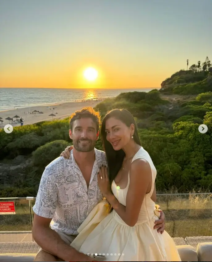 As they watched the sunset from the beach, Nicole wore a cream mini-dress and Thom wore a shirt and shorts as the couple shared images from their night out on the town.