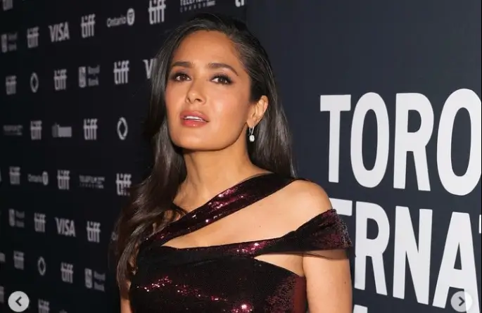 On the red carpet, Salma Hayek showed off her natural greys wearing a burgundy sequin dress that accentuated her womanly curves