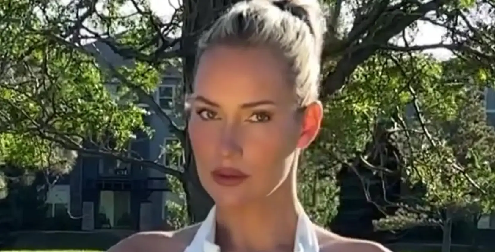 Paige Spiranac, 31, risked a wardrobe malfunction with a slow-motion video of her chipped a ball out of the bunker in extremely low-cut top