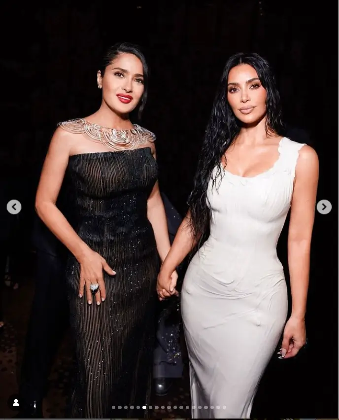 In a strapless dress with a sparkly pinstripe layer on top, Salma stunned with a chic updo, a bold red lip, and a dramatic silver crescent necklace.