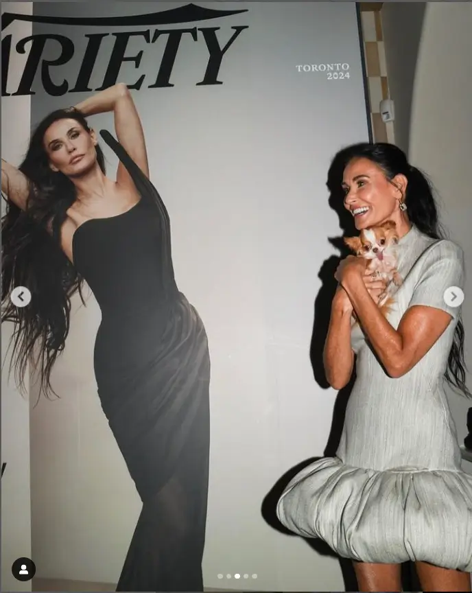 She posed for photos in front of the wooden wall wearing a white Coperni dress featuring a ruffled skirt and mock neck, which she wore to celebrate appearing on Variety's cover.