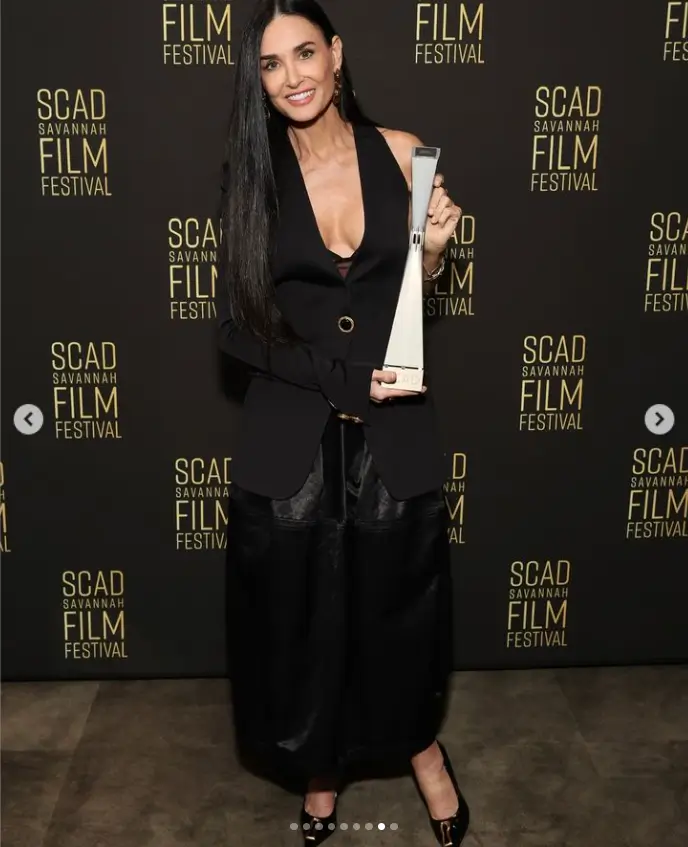 A low-cut vest flashes Demi Moore's cleavage as she prepares to be honored at SCAD Savannah Film Festival