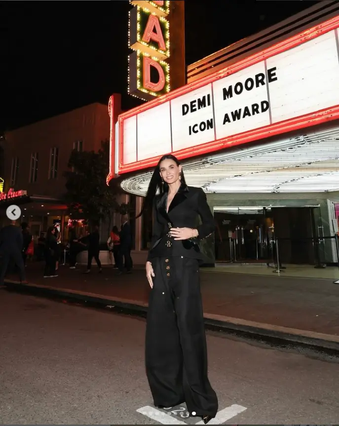 In a low-cut vest, Demi Moore flashes her cleavage on the red carpet at the SCAD Savannah Film Festival in Georgia.