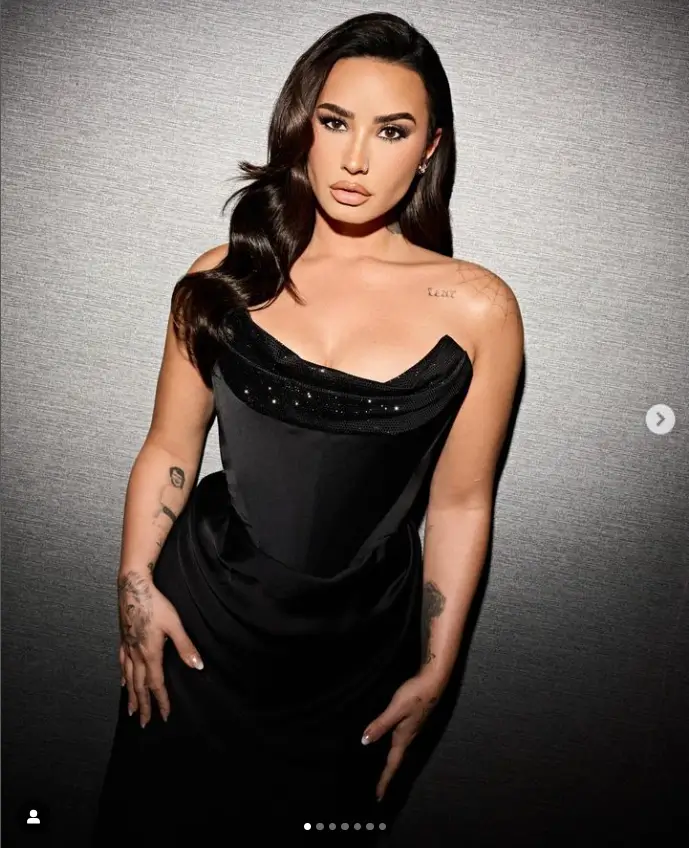 Demi Lovato donned a slinky ruched dress in glam mode. She showed off her killer figure in a strapless black dress and sparkly gear, sporting retro curls and dramatic eye makeup.