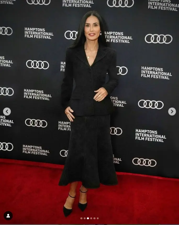 Featuring a flawlessly glowing complexion and long, dark hair, Demi Moore wore a black blazer and gray skirt paired with delicate jewelry.