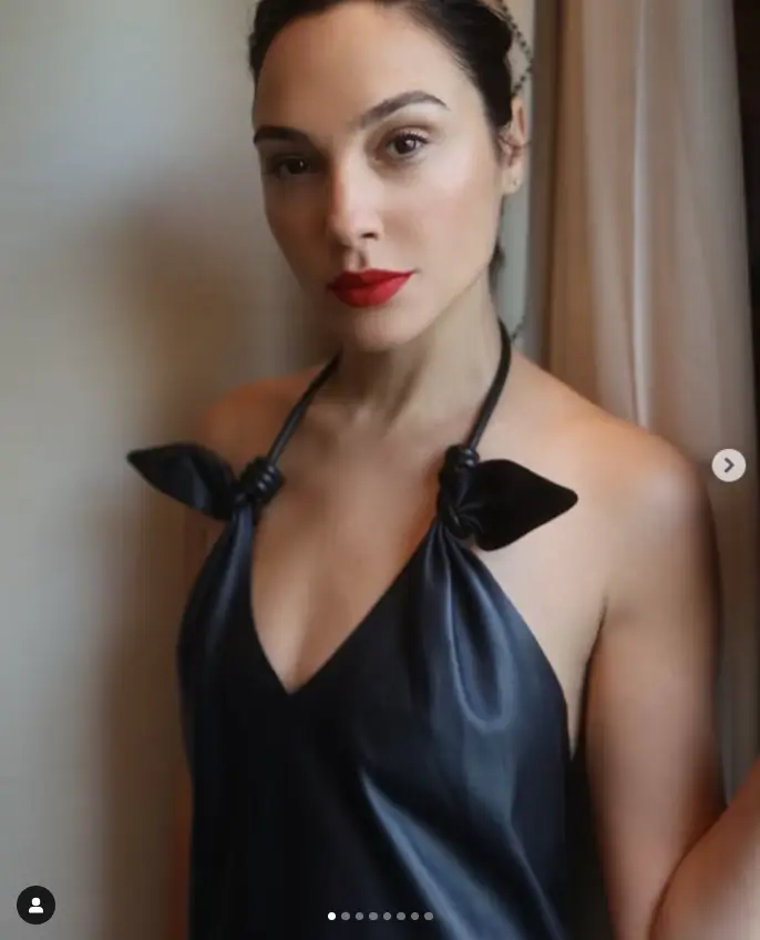 As Gal Gadot attended the Loewe Fashion Show, she showcased her model physique in a braless leather dress featuring a halterneck style and a maxi length.