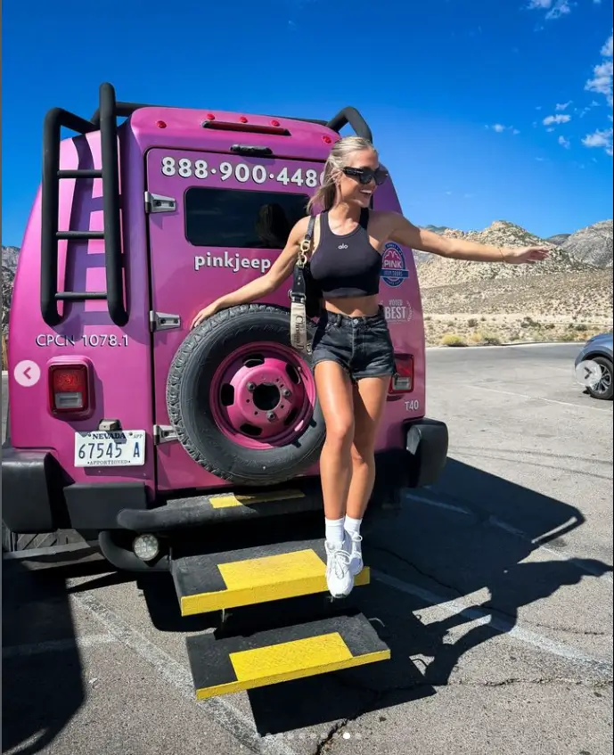 With her blonde hair styled up half-up and half-down, Molly appeared in high spirits while posing in a pink Jeep