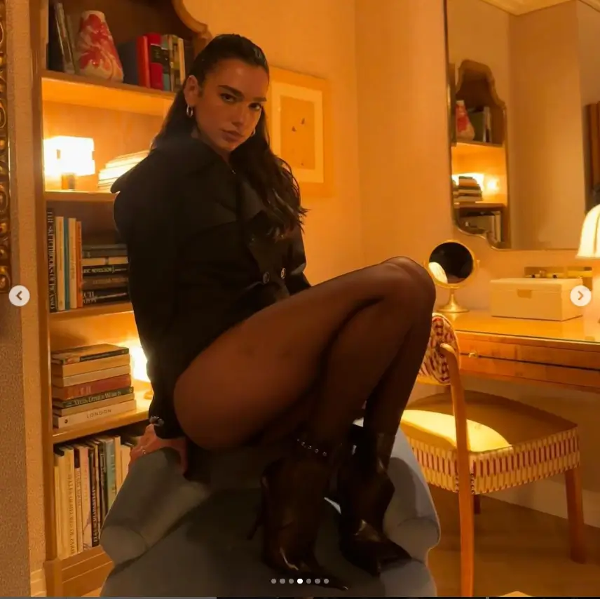 A series of racy photos of Dua Lipa on Instagram showed her long legs in a black bodysuit, sheer tights, and high heels.